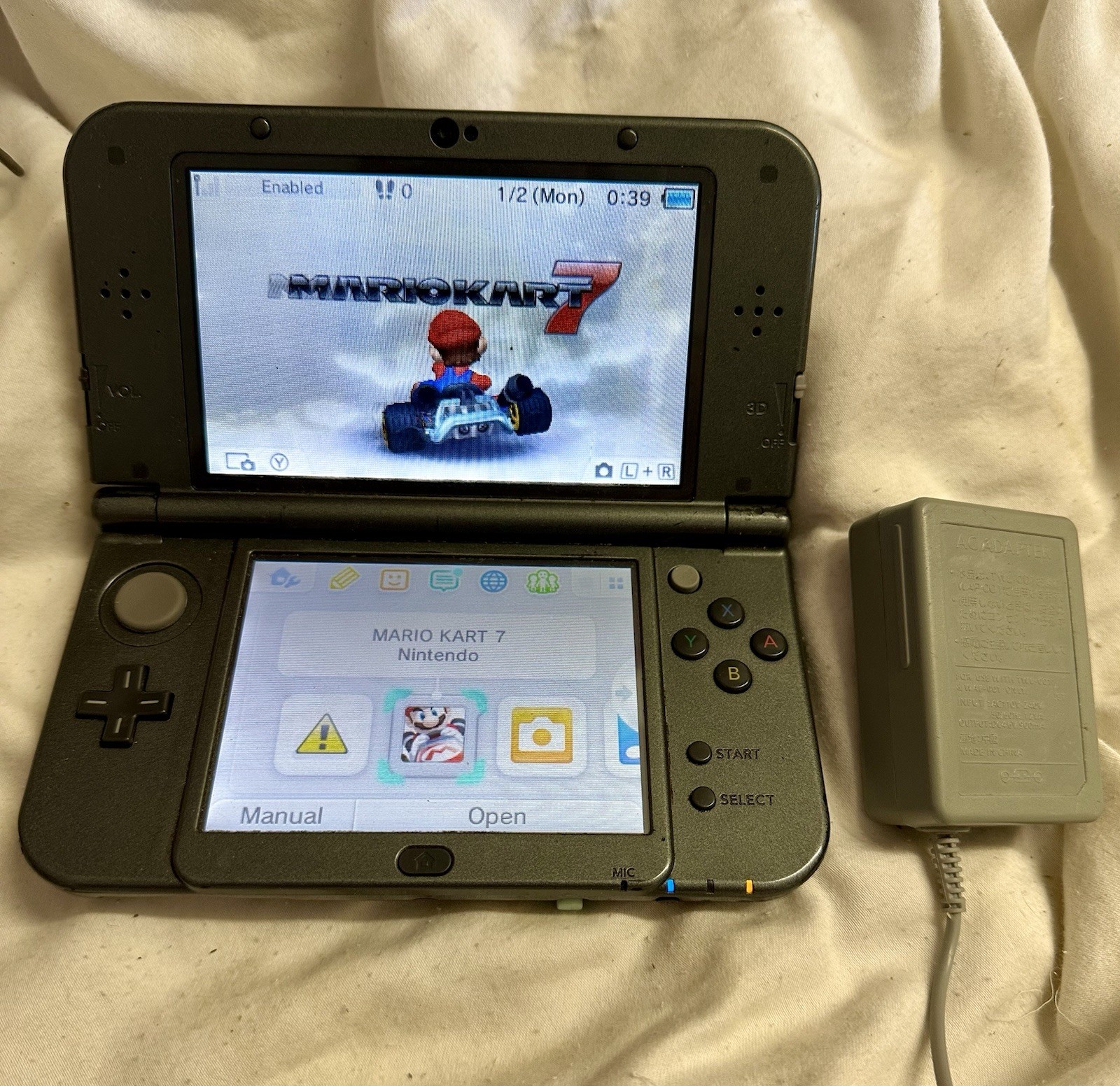 Nintendo “New”3DS XL Black System RED-001 W/ Charger , Mario Kart 7 & Carry Case