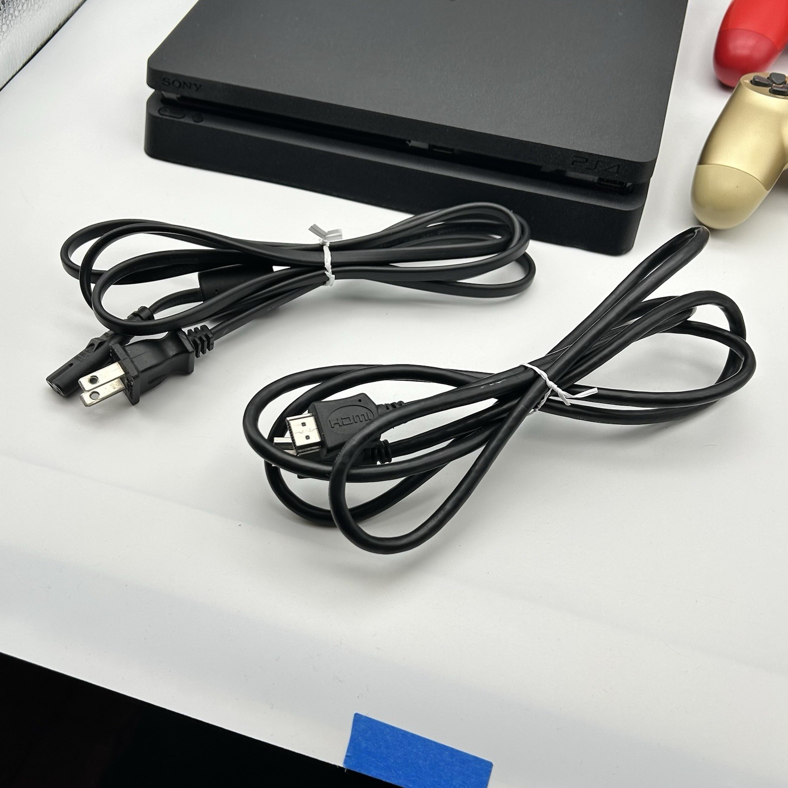 Sony PS4 Slim 1TB Console Bundle [Includes 2 Controllers, Power Cord, HDMI Cord]