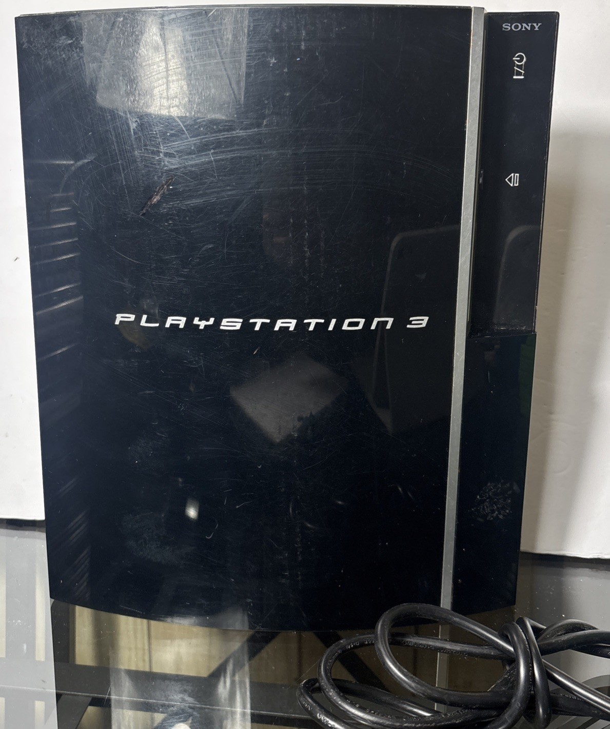 Black PlayStation 3 Console With Charging Cable