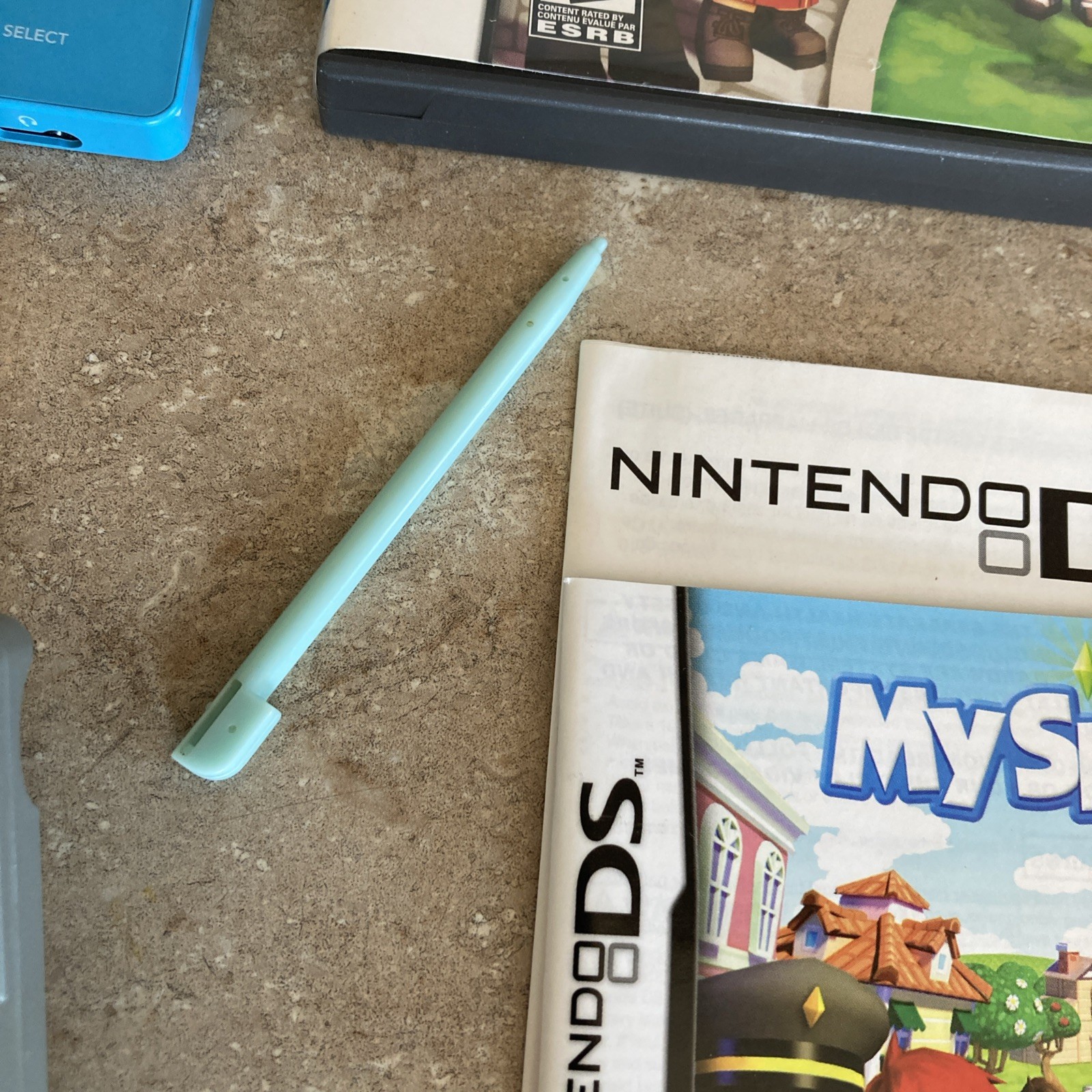 Nintendo DSi Light Blue Handheld Console Game System W/Sims Game Good Condition