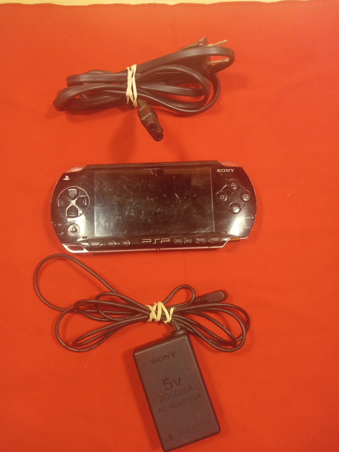 PSP 1001 CONSOLE+AC ADAPTER/NO TOGGLE BUTTON OR BATTERY & COVER/ SEE…