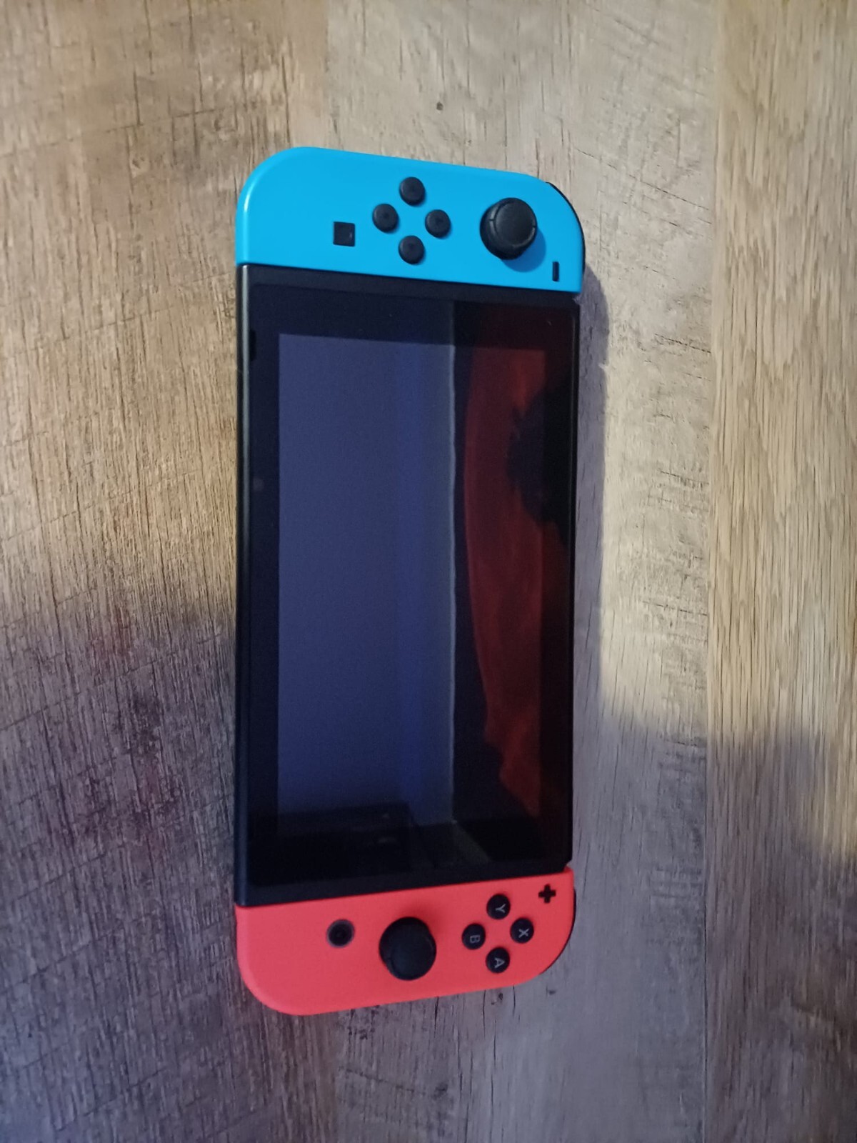 Nintendo switch- Black- Red and blue joycons- Slightly used- Good condition 