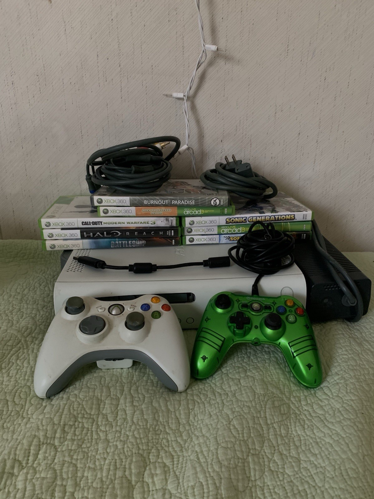 A White Xbox 360 With 2 Controllers And 8 Games.