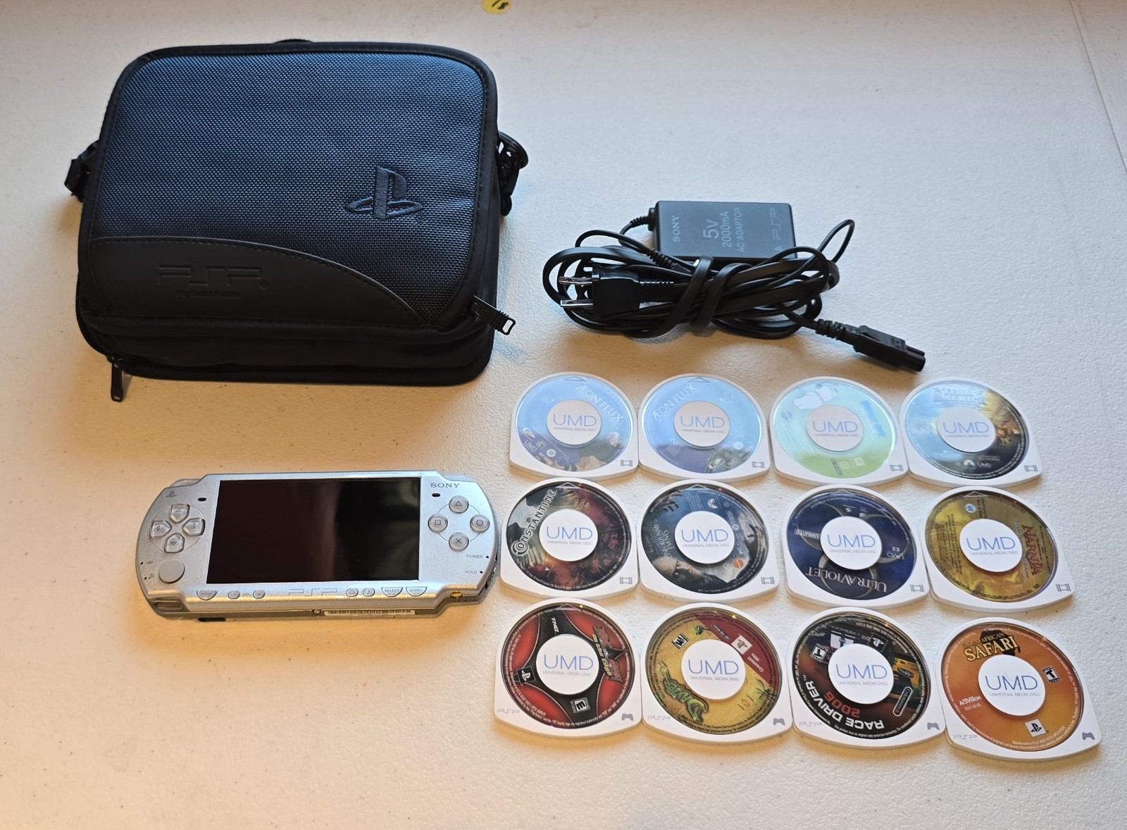 Sony Playstation Portable PSP-2001 Silver W/ Charger Games, UMD’s & travel case